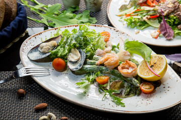 Fresh seafood salad. Salad with shrimp and oysters in sauce