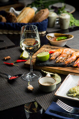 glass of white table wine with a variety of snacks. Dry white wine in the glass.