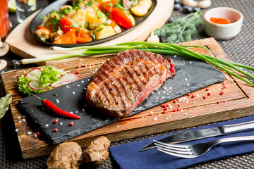 Big deep-fried beef steak. Roast vegetables in a Georgian restaurant. Georgian cuisine.