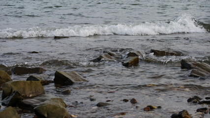 wave with stones on the shore
