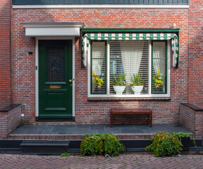 Typical Dutch village houses facade in Volendam. North Holland, Netherlands.