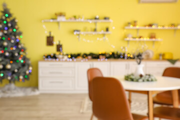 Interior of modern kitchen decorated for Christmas, blurred view