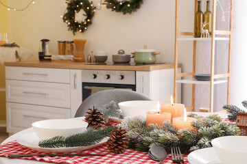 Beautiful table setting for Christmas dinner in kitchen