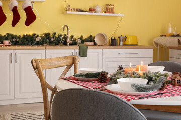 Beautiful table setting for Christmas dinner in kitchen