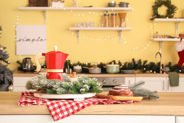 Coffee pot with Christmas decor on table in kitchen
