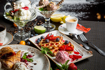 sweet Viennese waffles with syrup and sauce. Fresh fruit and berries in dessert. sweet dessert.