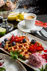 sweet Viennese waffles with syrup and sauce. Fresh fruit and berries in dessert. sweet dessert.