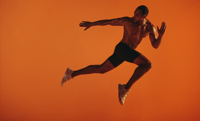 Fototapeta na wymiar Bare chested male athlete running