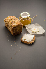 Sandwich with butter and black bread and honey