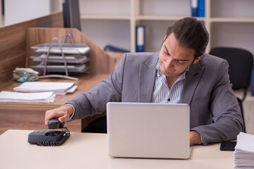 Young male employee working in the office