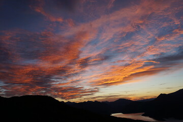 red sunset over the mountains and lake of Serre Ponçon, France
