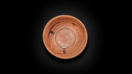 Wooden bowl on a black background.