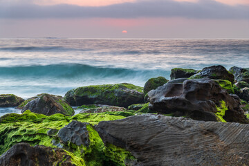 Beautiful sunrise with high cloud and headland at the seaside
