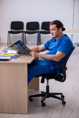 Young male doctor radiologist being unhappy after night shift