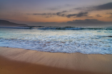 Beautiful sunrise with high cloud and headland at the seaside