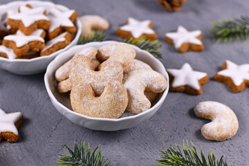 Crescent shaped christmas cookies called 'Vanillekipferl', a traditional Austrian or German Christmas biscuits with nuts and icing sugar in bowl