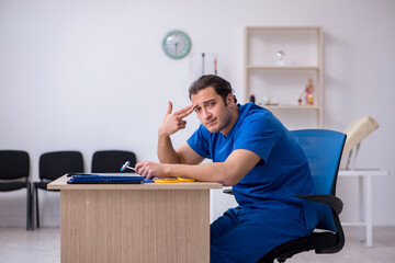 Young male doctor being unhappy after night shift