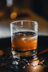 Refreshing alcoholic cocktail. Whiskey and coke. Ice in a glass, mixing ingredients.