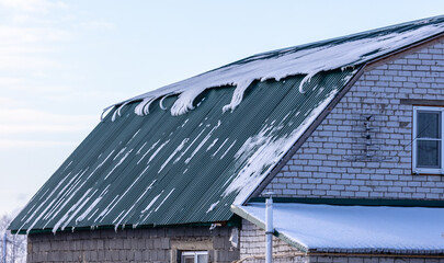 Snow on the roof of the house.