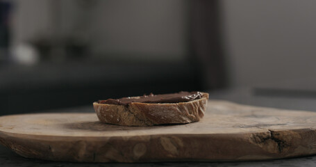 chocolate hazelnut spread on ciabatta slice on wood board