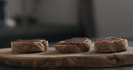 chocolate hazelnut spread on ciabatta slice on wood board