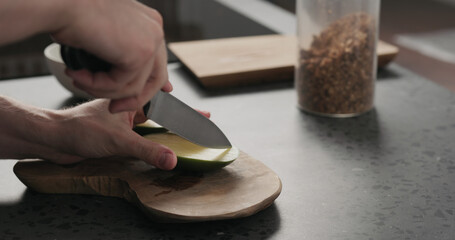 man cut green mango on olive wood board