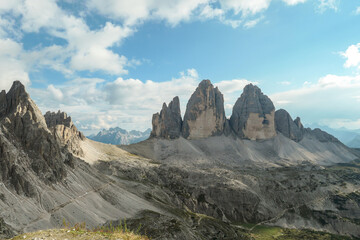 A panoramic capture of the famous Tre Cime di Lavaredo (Drei Zinnen) and surrounding mountains in Italian Dolomites. The mountains are surrounded by thick clouds. A lot of landslides. Serenity