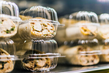 Pre-packaged sandwiches put up for sale in a commercial fridge
