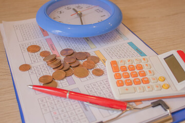 Business, finance, saving money, banking, loan, investment, taxes or accounting concept : Coins stack, calculator, pen a clock