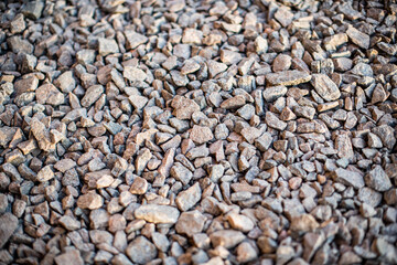 Colorful small pebbles. gravel texture on the background. Texture of little rocks. Small stones, little rocks, pebbles in many shades of grey, white, brown, yellow colour.
