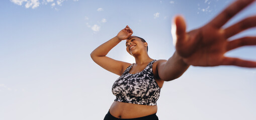 Plus size woman relaxing after workout