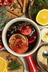 Spicy mulled wine with ingredients around. Pot of mulled wine, traditional christmas drink.