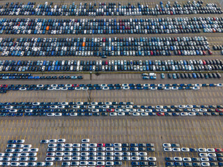 Top view of many parked cars waiting for shipping aerial drone view lined up structured