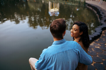 Fototapeta premium Love couple embracing at the pond in summer park