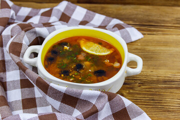 Traditional russian hodgepodge soup on a wooden table