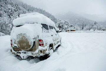frozen car in the snow in the mountains in the Western Caucasus
