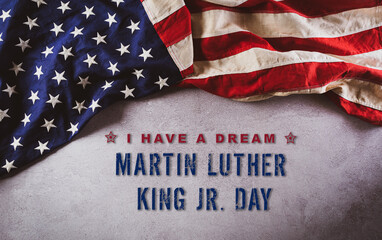 Fototapeta na wymiar Happy Martin Luther King Day concept. American flag againt dark stone background