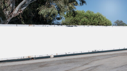 Long empty white hoarding with mock up place at city street.