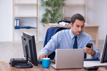 Young male employee working in the office