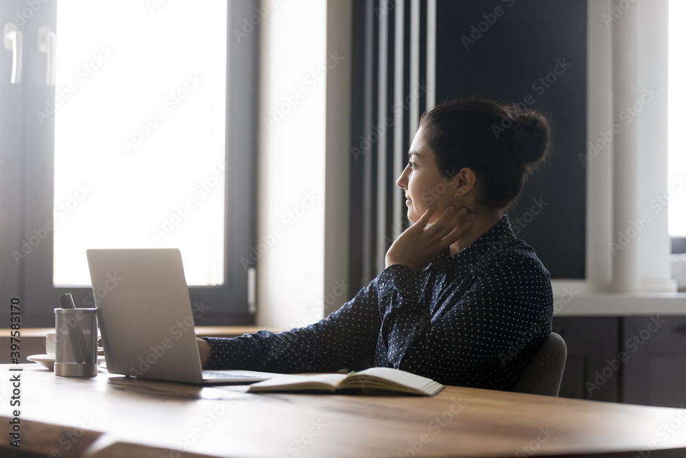 Poster daydreaming. smiling young mixed race female taking short break in distant working learning lost in 