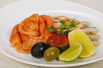 Sliced fish snack with salmon, caviar and strugeon