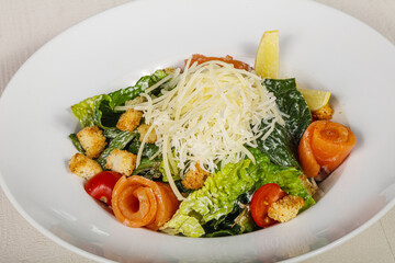 Caesar salad with salmon and cheese