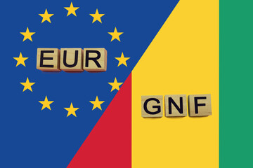 United Europe and Guinea currencies codes on national flags background