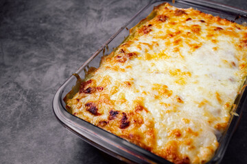 Close up and top view of a delicious and freshly baked homemade lasagna isolated and with copy space.