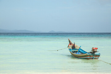 the boat in azure water at the beach in Thailand