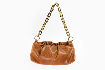 women handbag hanging against white background. Beautiful luxurious bright brown leather handbag front view, without shadow on white background
Handbag isolated hangs on black chains