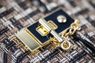 Close up of the lock of a ladies handbag. Fabric bag with gold clasp. Fashion concept  Luxury fabric woman's handbag. Golden lock of a fashionable bag. detailed Top view