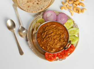 Rajasthani Famous Traditional Cuisine Haldi Sabji or Tukkar Served with Salad on White Background