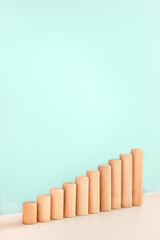 Growth bar chart, graph diagram made with wooden block on blue background and copy space. Business progress strategy, sales and marketing concept. Vertical orientation