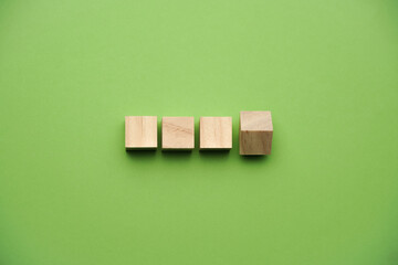 A wooden cube on green backgroud, business, finance and education concept